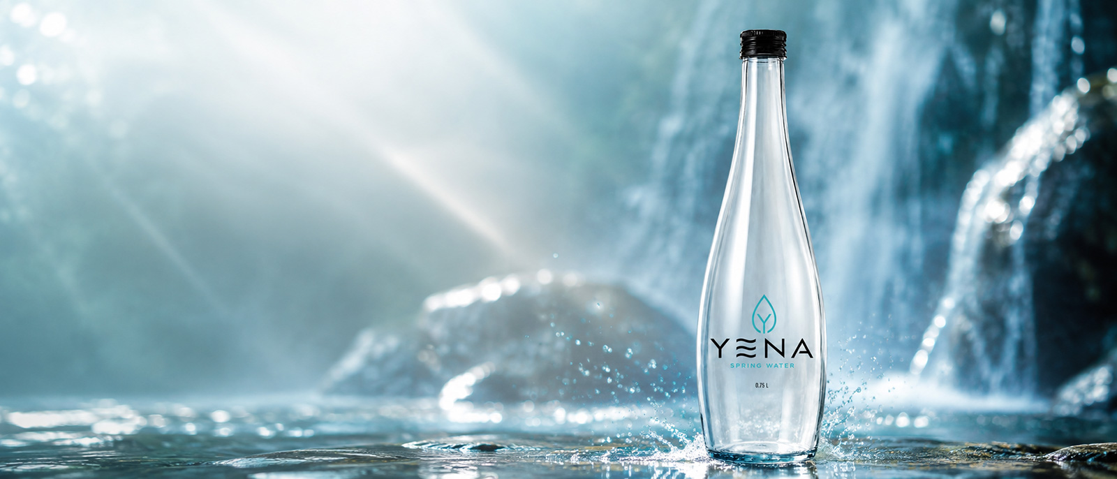 YENA 0.75L glass water bottle by a waterfall